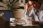 Person reviewing receipts and paperwork during tax preparation